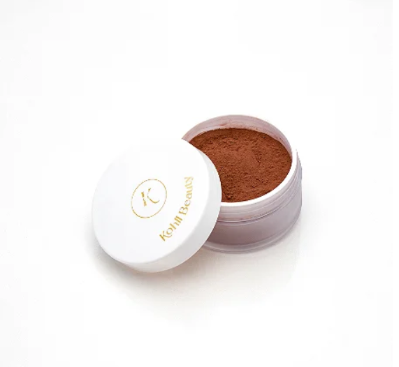 Pó bronzeador ou blush em pó solto castanho em recipiente branco com tampa aberta