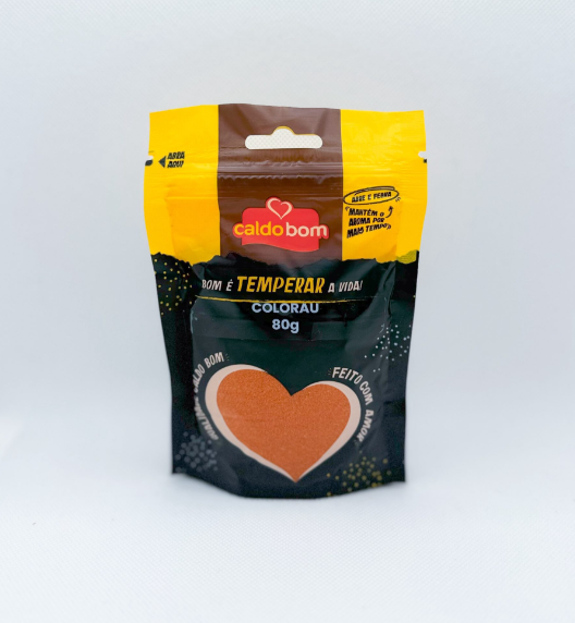 Pacote de tempero colorau Caldo Bom de 80g com design amarelo, castanho e preto e um coração laranja no centro.