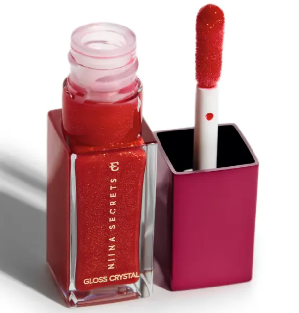 Frasco aberto de gloss labial vermelho brilhante com aplicador esponjoso