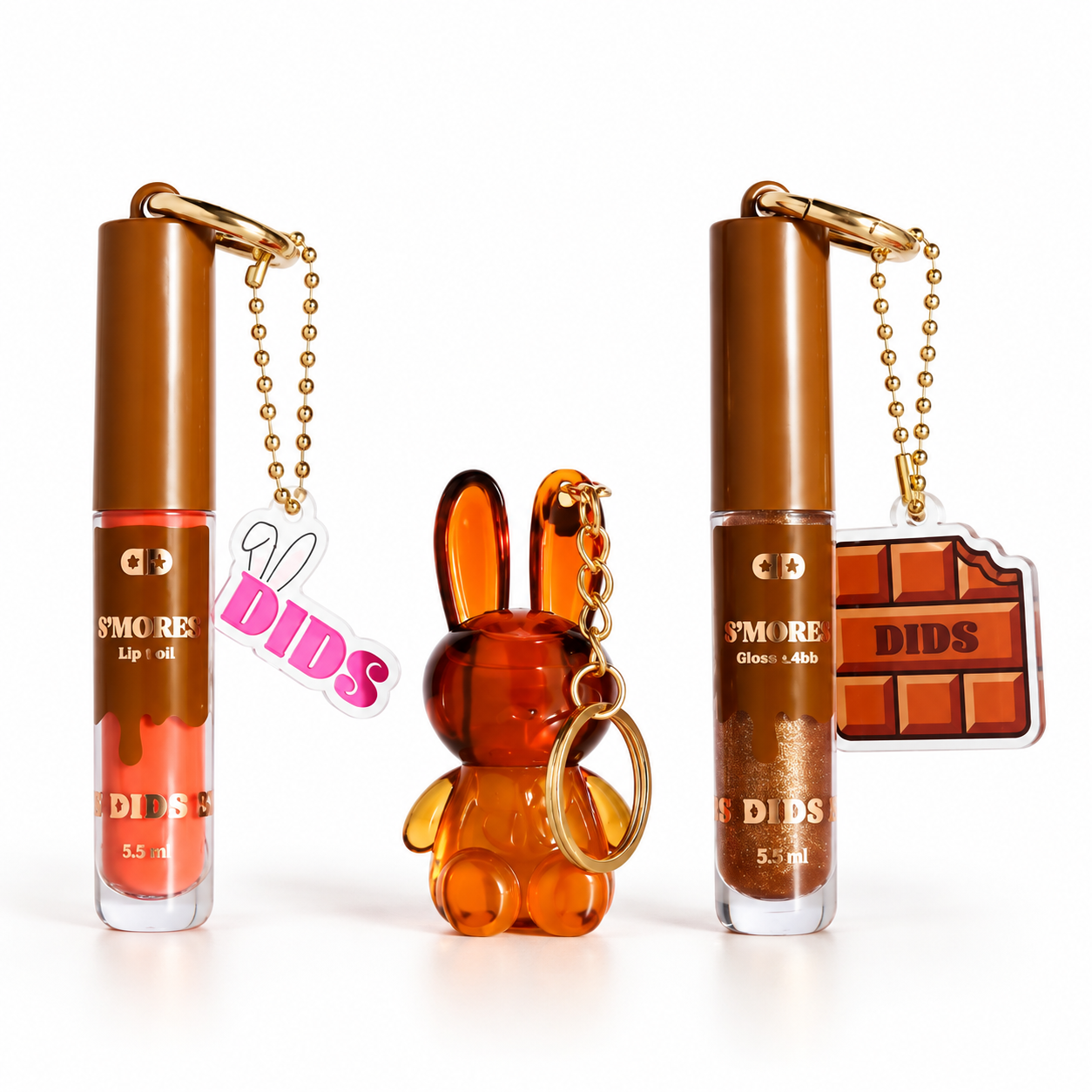 Duas embalagens de óleo labial e gloss com chaveiros e figura de coelho âmbar translúcido.