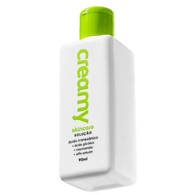 Frasco branco de plástico com tampa verde para cuidados de pele com texto em verde e preto