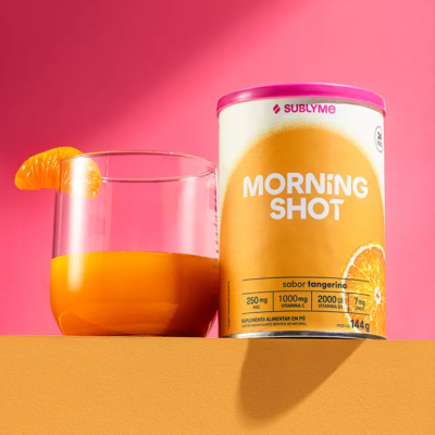 Lata Morning Shot sabor tangerina ao lado de copo com bebida e fatia de tangerina
