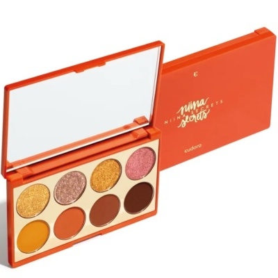 Paleta laranja de sombras com espelho e várias cores, incluindo dourado e castanho.