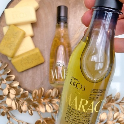 Frascos de óleo Natura Ekos Maracujá e sabonetes naturais decorados com ramos dourados