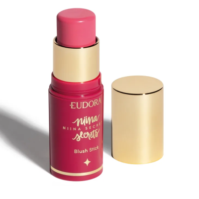 Blush em stick cor-de-rosa Eudora Ninna's Secret com embalagem vermelha e tampa dourada