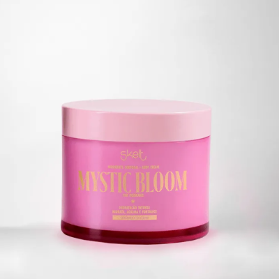 Creme corporal Mystic Bloom em embalagem rosa com texto dourado num fundo branco.