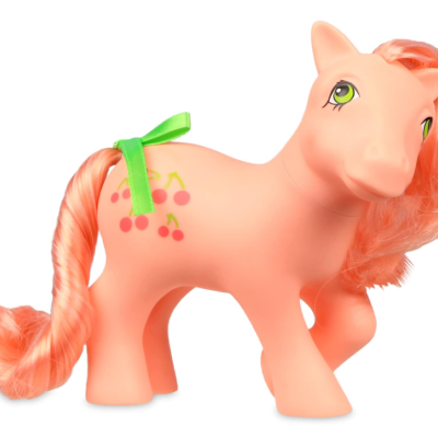 Boneco de cavalo rosa com cerejas e laço verde na cauda.