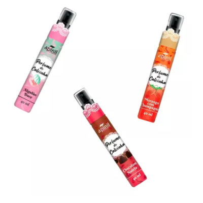 Três frascos de spray perfumado Apinil em rosa, vermelho e laranja