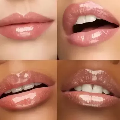 Close-up de lábios femininos com gloss labial rosado nude brilhante