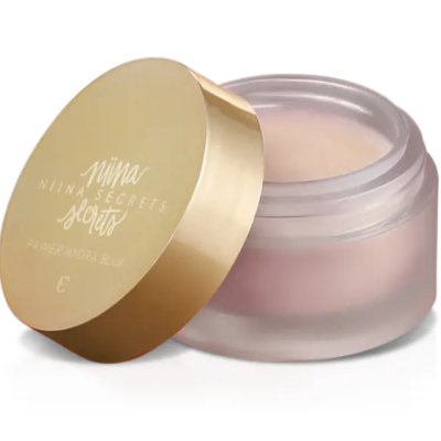 Frasco de creme transparente com tampa dourada e texto NIINA SECRETS