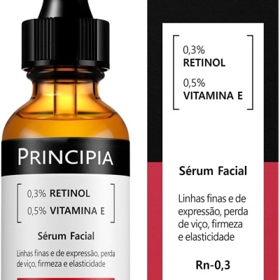 Frasco ambar de sérum facial com conta-gotas preto e rótulo branco e preto ao lado de embalagem preta e vermelha com texto.