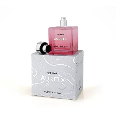 Frasco rosa de perfume AURETX sobre caixa cinzenta com padrão branco