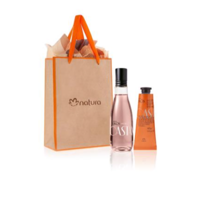 Conjunto com saco de papel kraft laranja, garrafa rosa e tubo de creme laranja