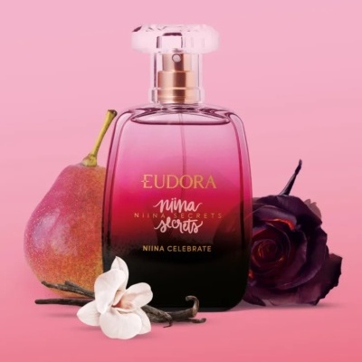 Perfume Eudora Niina Secrets Niina Celebrate com pera, flores e baunilha em fundo rosa
