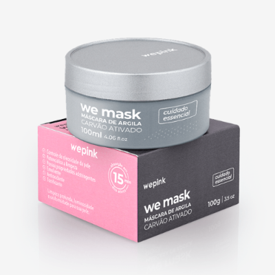 Frasco de máscara de argila cinzento com tampa prateada em cima de caixa rosa e preta com texto