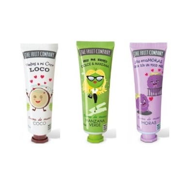 Três tubos coloridos de creme da THE FRUIT COMPANY com ilustrações divertidas de frutos e texto em espanhol