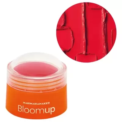 Frasco laranja com tampa transparente e produto vermelho