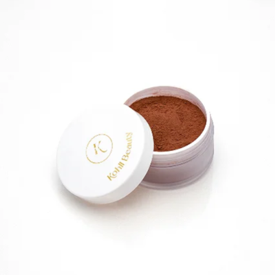 Pó bronzeador ou blush em pó solto castanho em recipiente branco com tampa aberta