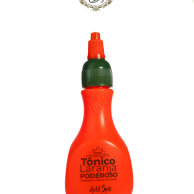 Frasco laranja de tónico capilar com tampa verde e bico dosificador