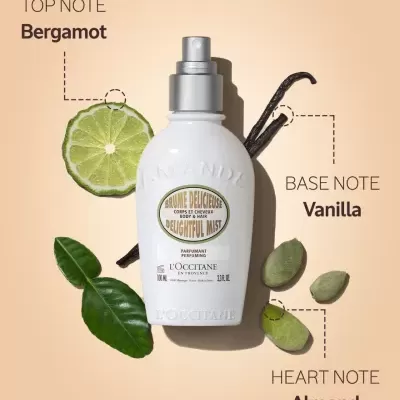 Frasco branco de spray de perfume com bergamota, baunilha e amêndoas ao redor