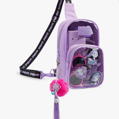 Mochila pequena lilás com bolso transparente e pendente rosa.