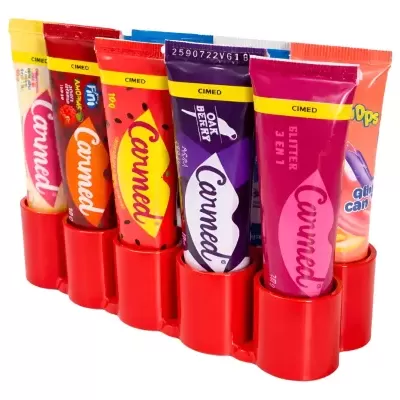 Seis tubos coloridos de pasta Canned com selo CIMED organizados num suporte vermelho