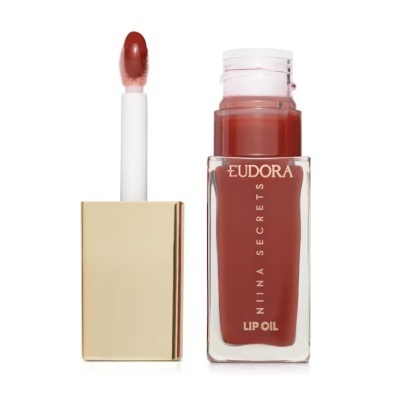 Óleo para lábios Eudora Niina Secrets vidro transparente tampa dourada aplicador branco texto dourado