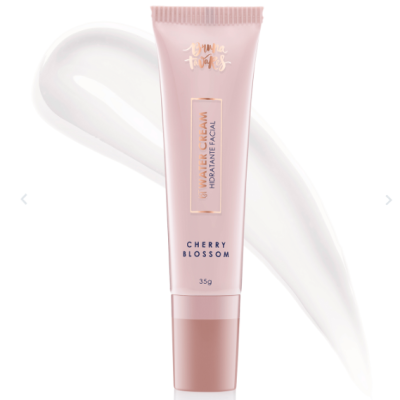 tubo de creme hidratante facial rosa com texto dourado e preto