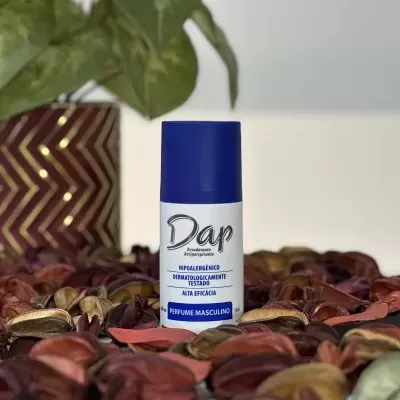 Frasco de desodorizante Dap branco com tampa azul e texto azul e preto