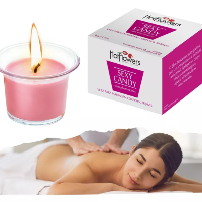 Vela rosa em vidro acesa com embalagem de vela para massagem e mulher a receber massagem