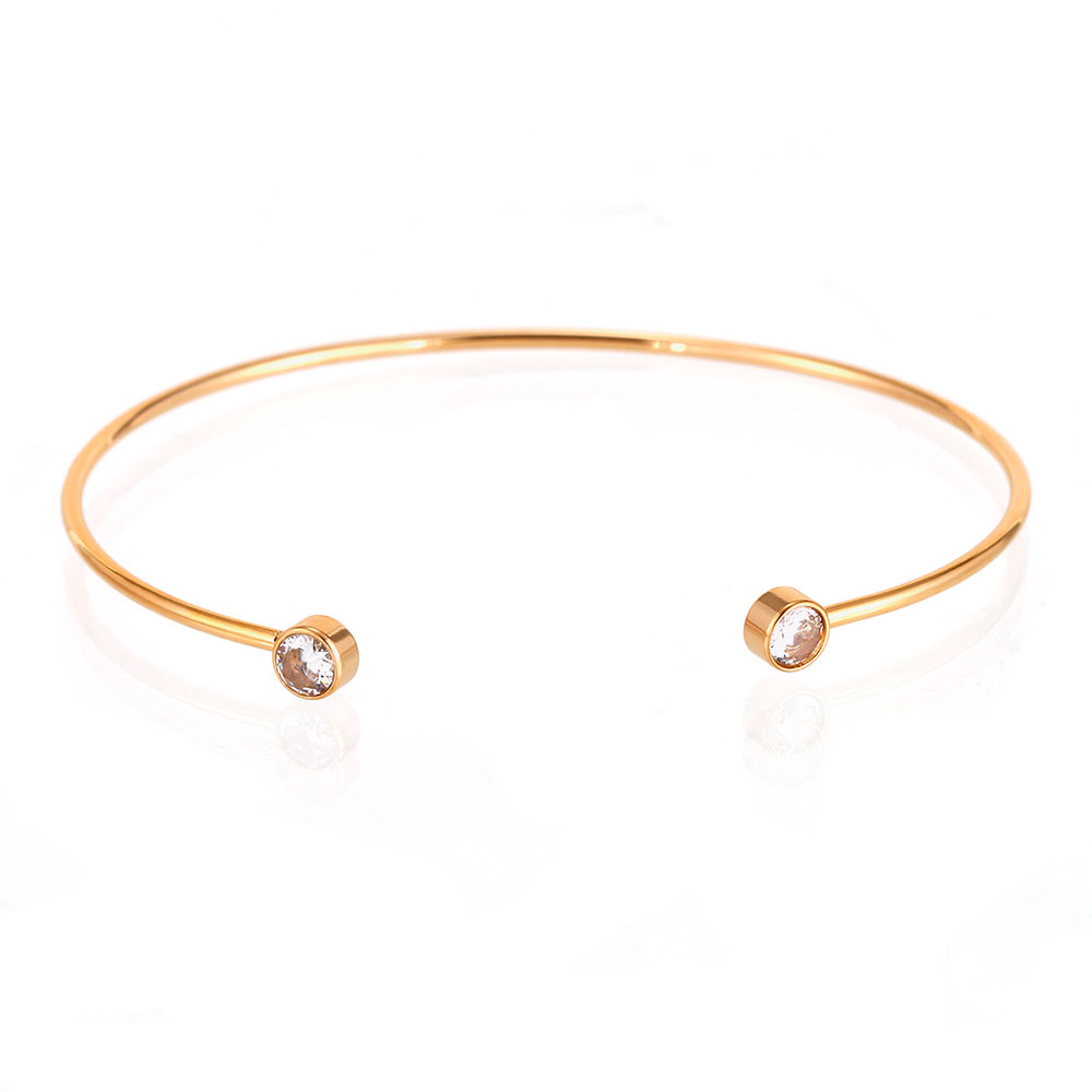 Pulseira fina dourada aberta com pedras nas extremidades