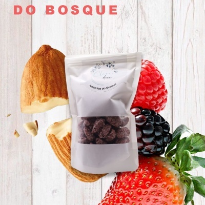 Embalagem branca de amêndoas cobertas Amêndoa do Bosque com frutas em fundo de madeira clara