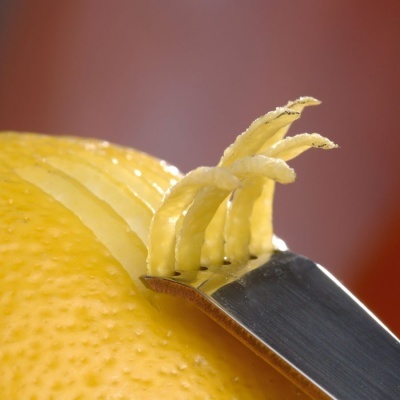 Utensílio a retirar tiras finas da casca de limão amarelo