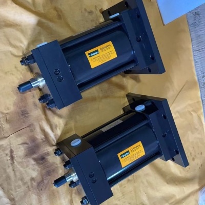 Duas unidades de cilindro hidráulico preto com etiquetas amarelas Parker sobre papel castanho