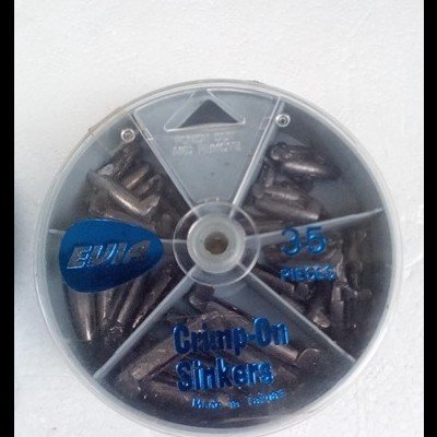 Caixa redonda transparente contendo 35 chocadeiras de chumbo para pesca, dividida em cinco compartimentos, com texto azul no topo.