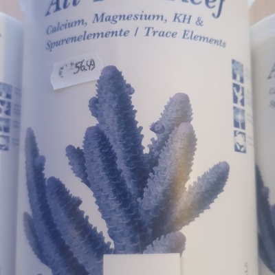 Embalagem branca All-For-Reef Tropic Marin com coral azul e texto azul