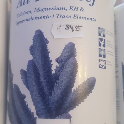 Recipiente branco do produto All-For-Reef com coral azul e texto da marca Tropic Marin