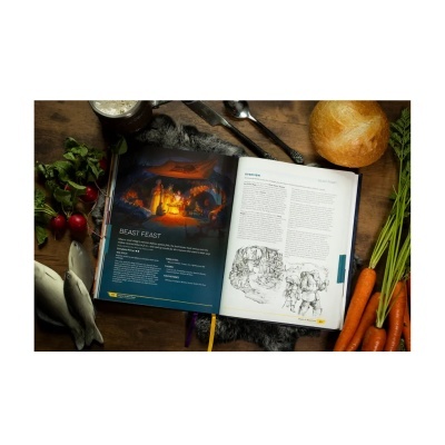 Livro aberto com texto BEAST FEAST, pão, cenouras, rabanetes, peixes e talheres numa mesa de madeira