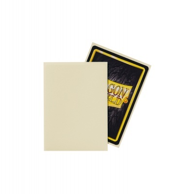 Duas cartas de jogo, uma com verso preto e amarelo com texto DRAGON SHIELD, outra com frente creme clara