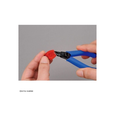 Mãos segurando objeto vermelho e alicate azul