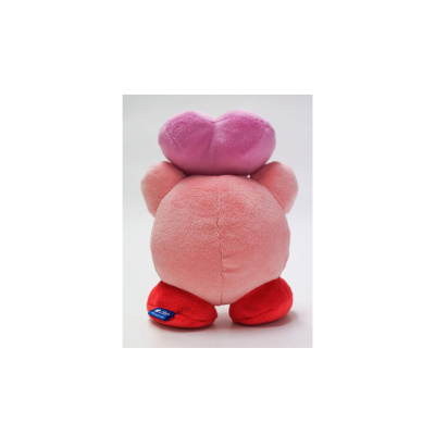 Urso de peluche rosa com laço e calça vermelha visto de costas