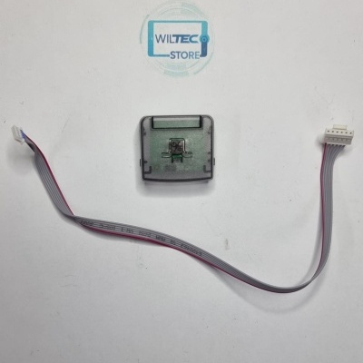 Cabo plano cinzento com conectores brancos e componente eletrónico com cobertura cinzenta em fundo branco