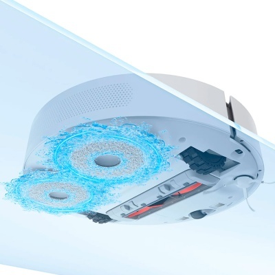 Aspirador robô branco visto de baixo com escovas circulares azuis em movimento