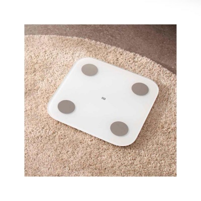 Balança digital branca e cinzenta sobre tapete bege