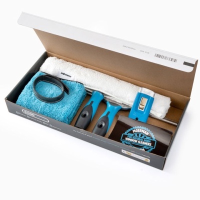 Kit de limpeza de janelas com rolos de borracha e panos em caixa aberta