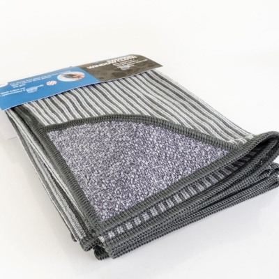 Tapete cinzento com riscas e parte inferior antiderrapante na embalagem