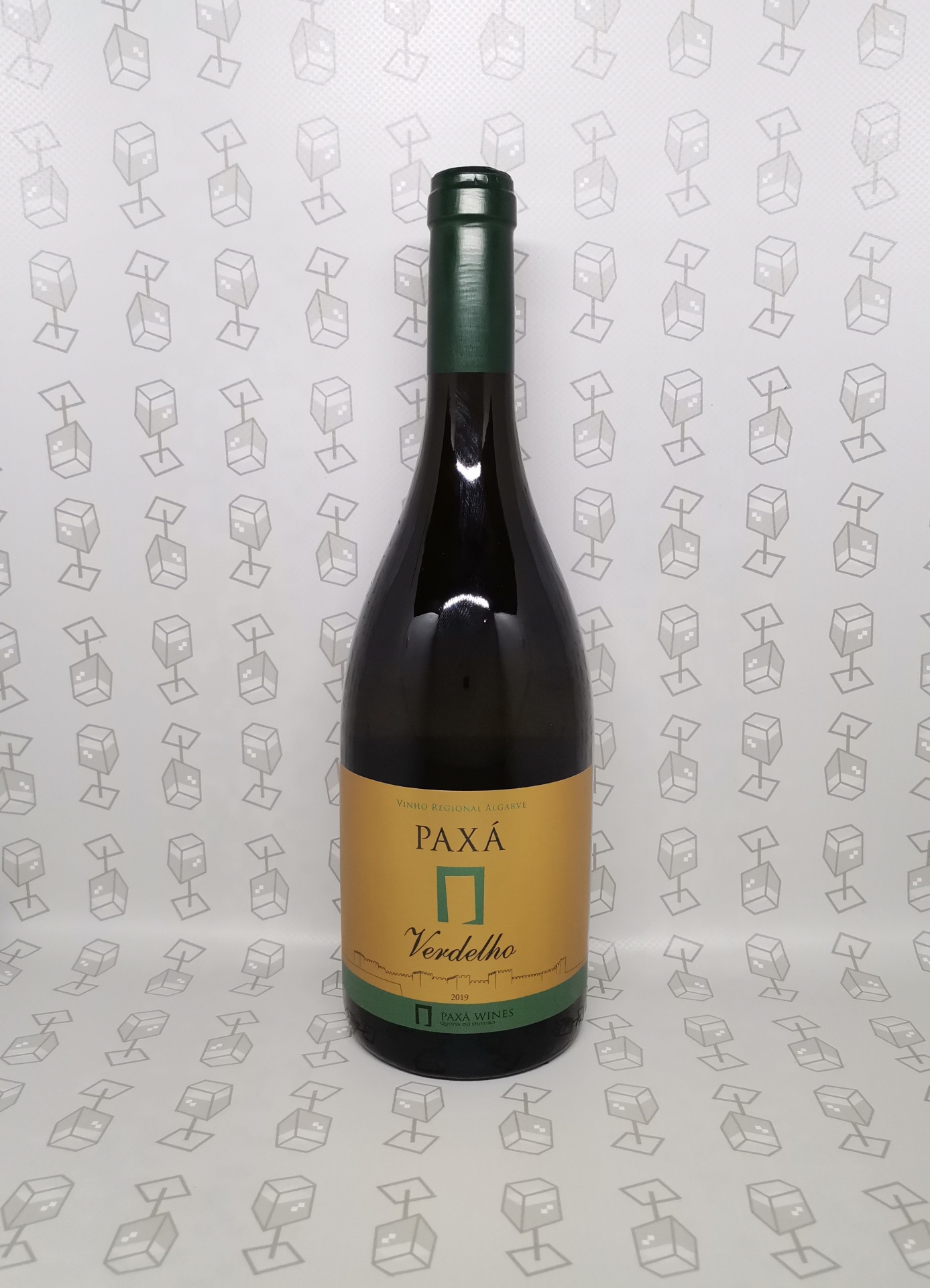 Garrafa de vinho Paxá Verdelho com rótulo amarelo e verde e padrão de cubos ao fundo