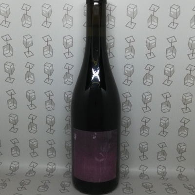 Garrafa de vidro escuro com rolha vermelha e rótulo roxo em fundo com padrão de cubos