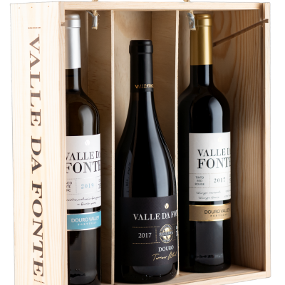 Caixa de madeira com três garrafas de vinho Valle Da Fonte, uma branca, uma preta e uma tinto