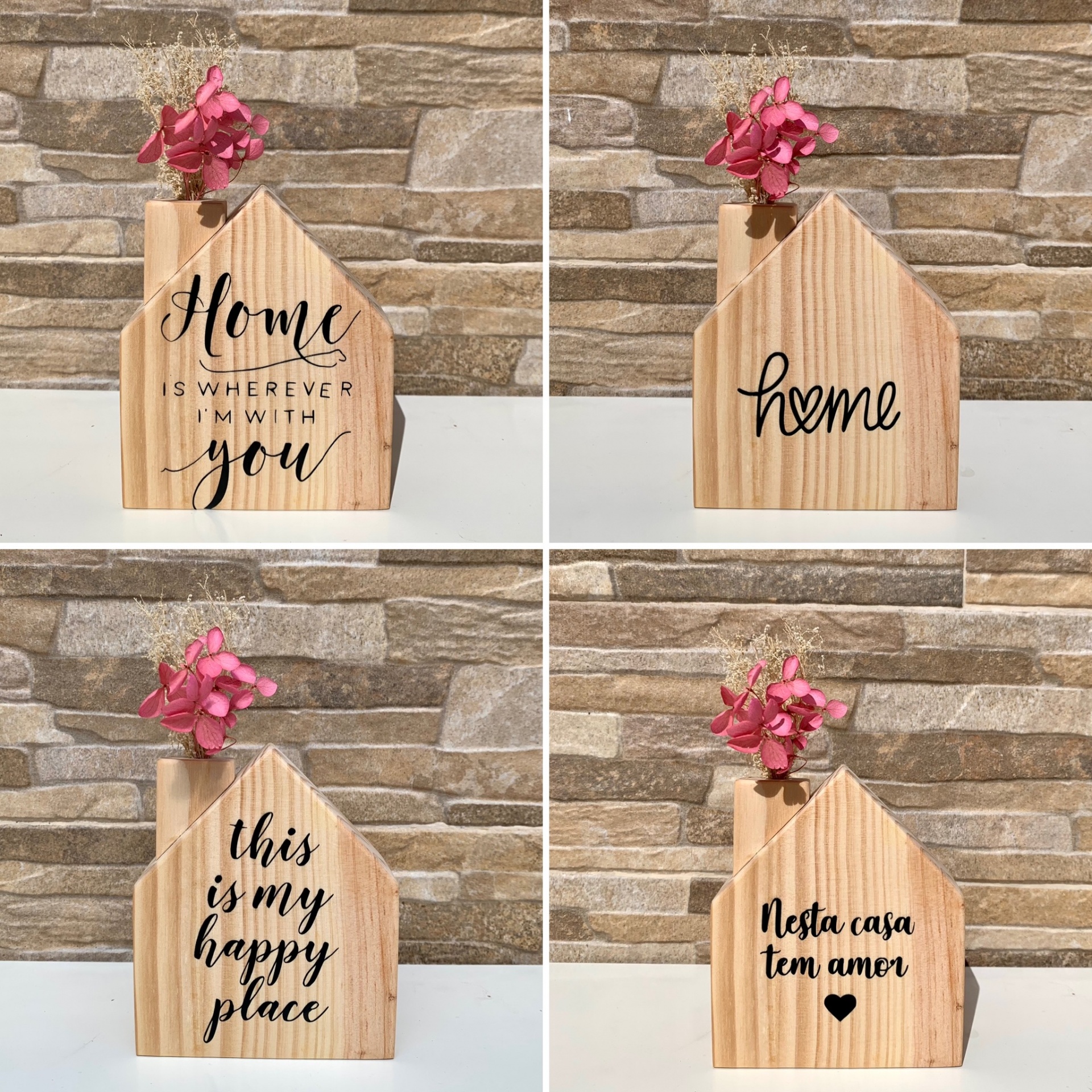Vasos decorativos de madeira em forma de casa com flores secas rosas e mensagens em inglês e português.